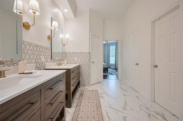 1942 Crisfield Dr, Sugar Land, TX 77479 - full bathroom with crown molding, marble look tiles, two vanities, and a wainscoted wall