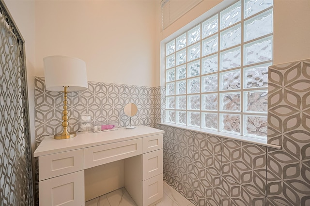 1942 Crisfield Dr, Sugar Land, TX 77479 - bathroom with tile walls, a wainscoted wall, and tile patterned floors