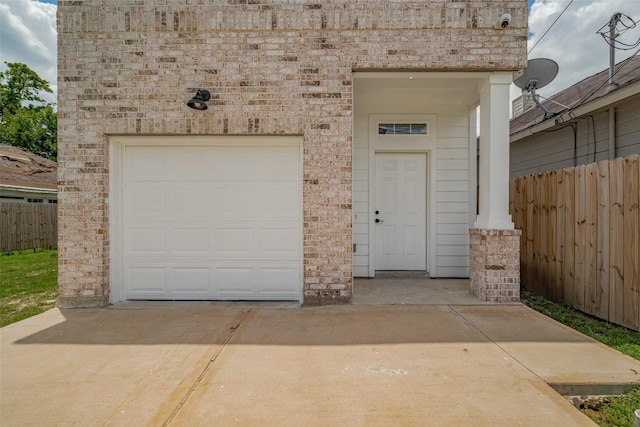 4116 Alvin St, Houston, TX 77051 - view of exterior entry featuring brick siding, a garage, and concrete driveway