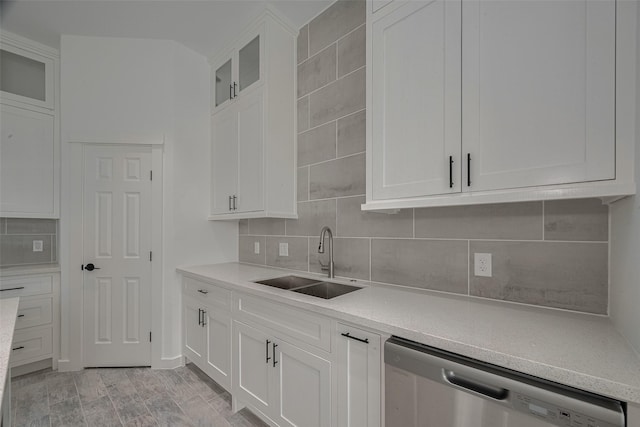 4116 Alvin St, Houston, TX 77051 - kitchen with stainless steel dishwasher, backsplash, and white cabinetry