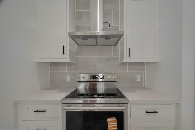 4116 Alvin St, Houston, TX 77051 - kitchen featuring stainless steel electric stove, wall chimney range hood, white cabinetry, and backsplash