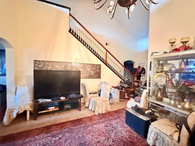 20702 Dappled Ridge Way, Humble, TX 77338 - living room featuring arched walkways, tile patterned floors, stairs, and vaulted ceiling