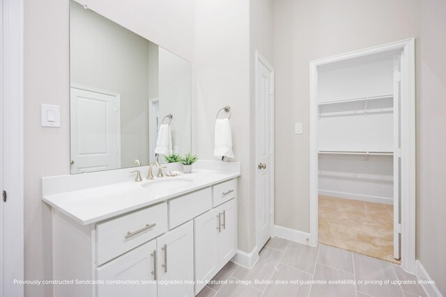 833 Fisher St Unit E, Houston, TX 77018 - bathroom with vanity, a walk in closet, baseboards, and tile patterned flooring