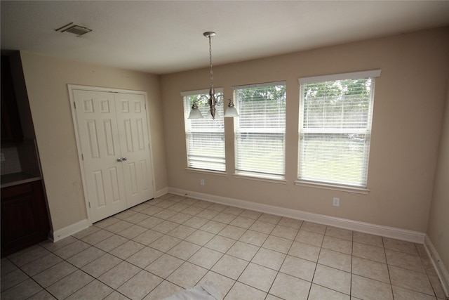 16218 Bresslyn, Cypress, TX 77429 - unfurnished dining area featuring a chandelier, baseboards, and light tile patterned floors
