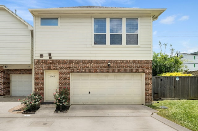 1765 Aden Dr, Houston, TX 77003 - view of front of home featuring a garage, brick siding, and driveway