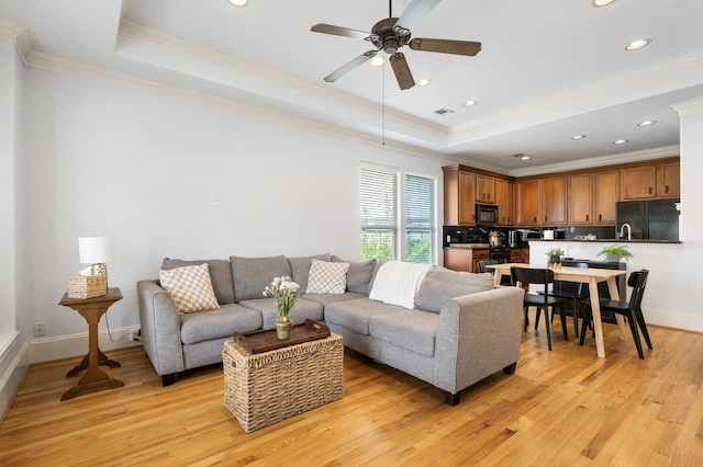 1765 Aden Dr, Houston, TX 77003 - living area featuring a raised ceiling, crown molding, ceiling fan, light wood-style flooring, and recessed lighting