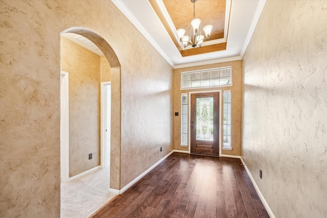22611 Pineleigh Ct, Tomball, TX 77375 - entrance foyer with arched walkways, hardwood / wood-style floors, a chandelier, ornamental molding, and a raised ceiling