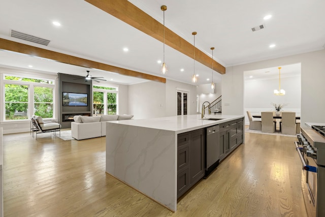 6001 Norhill Blvd, Houston, TX 77009 - kitchen featuring a sink, appliances with stainless steel finishes, light wood-style flooring, open floor plan, and recessed lighting