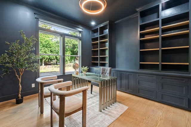 6001 Norhill Blvd, Houston, TX 77009 - office area featuring light wood finished floors, crown molding, and built in shelves