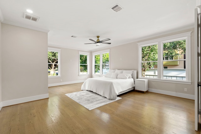 6001 Norhill Blvd, Houston, TX 77009 - bedroom with ornamental molding, baseboards, multiple windows, and light wood-style floors