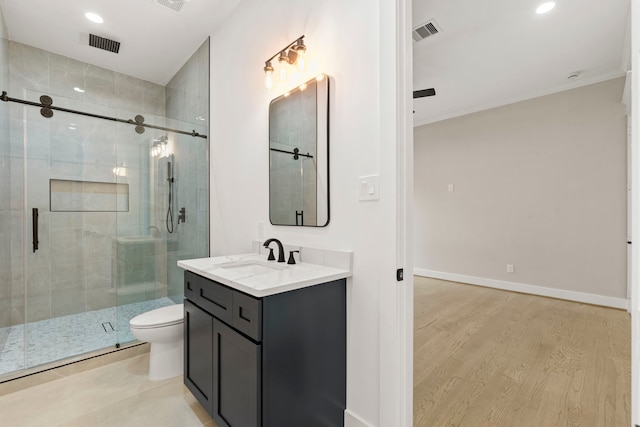 6001 Norhill Blvd, Houston, TX 77009 - bathroom with vanity, a stall shower, toilet, wood finished floors, and recessed lighting