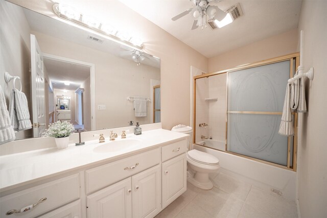 918 Dogwood Ridge Dr, Diboll, TX 75941 - full bath featuring a ceiling fan, toilet, vanity, tile patterned flooring, and bath / shower combo with glass door