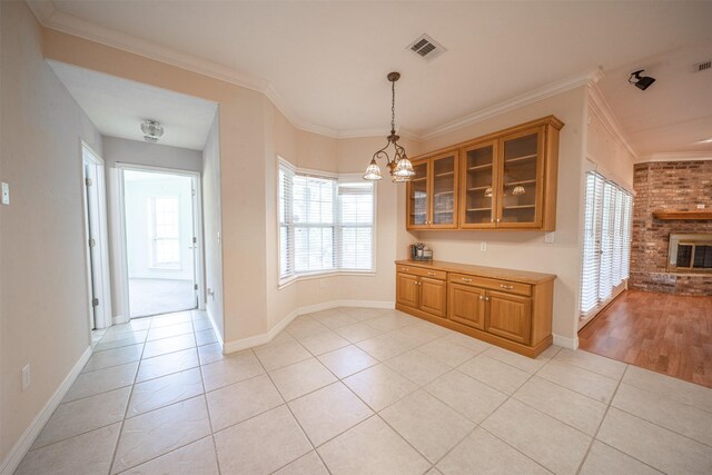 918 Dogwood Ridge Dr, Diboll, TX 75941 - unfurnished dining area with light tile patterned flooring, baseboards, a chandelier, and crown molding
