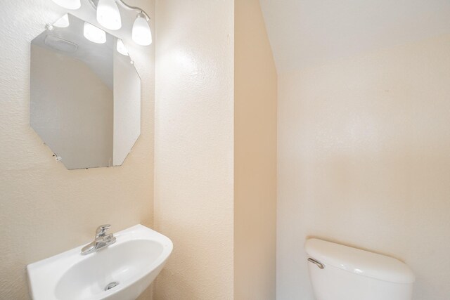 22802 Sherioaks Ln, Spring, TX 77389 - half bathroom featuring a sink and toilet