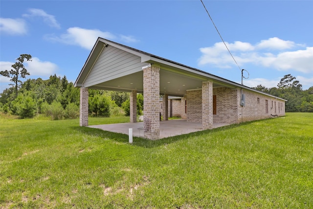 332 County Road 3567, Cleveland, TX 77327 - back of house with a lawn, brick siding, and a patio