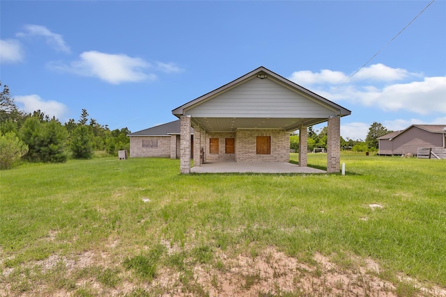 332 County Road 3567, Cleveland, TX 77327 - rear view of house featuring a patio area, a lawn, and brick siding