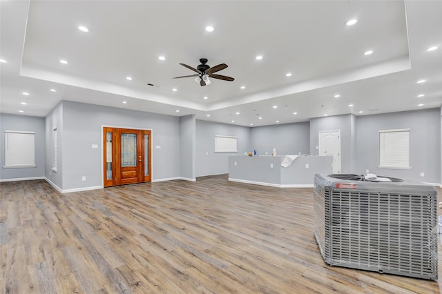 332 County Road 3567, Cleveland, TX 77327 - living room featuring a raised ceiling, light wood-type flooring, ceiling fan, and recessed lighting