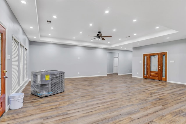 332 County Road 3567, Cleveland, TX 77327 - unfurnished living room with a tray ceiling, light wood-style floors, a ceiling fan, and recessed lighting