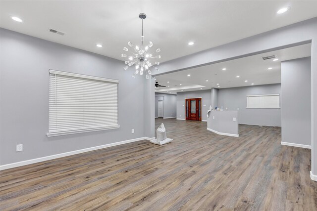 332 County Road 3567, Cleveland, TX 77327 - unfurnished living room featuring wood finished floors, recessed lighting, a chandelier, and ceiling fan