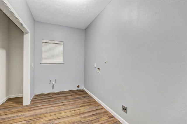 332 County Road 3567, Cleveland, TX 77327 - laundry room featuring gas dryer hookup, hookup for an electric dryer, wood finished floors, and a textured ceiling