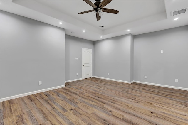 332 County Road 3567, Cleveland, TX 77327 - spare room featuring recessed lighting, ceiling fan, wood finished floors, and a raised ceiling