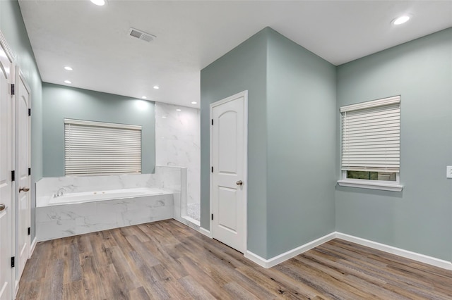 332 County Road 3567, Cleveland, TX 77327 - bathroom with a bath, wood finished floors, and recessed lighting