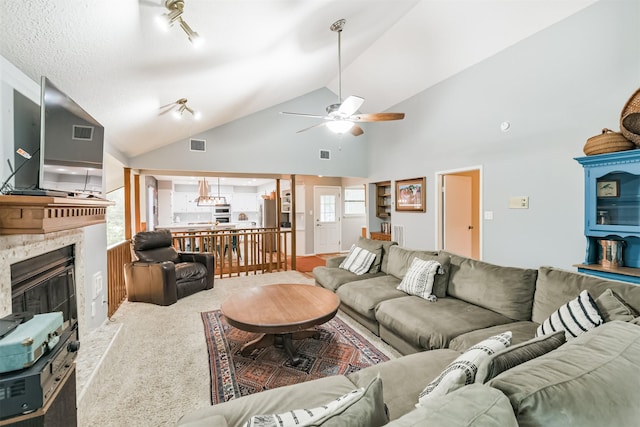 20002 18th Fairway Dr, Humble, TX 77346 - carpeted living room featuring a ceiling fan, a fireplace, and high vaulted ceiling