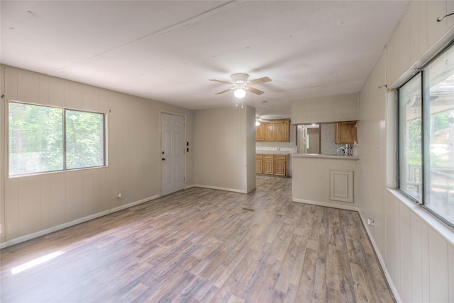 330 Oak Tree Dr, Point Blank, TX 77364 - unfurnished living room featuring light wood-style flooring, plenty of natural light, a ceiling fan, and baseboards