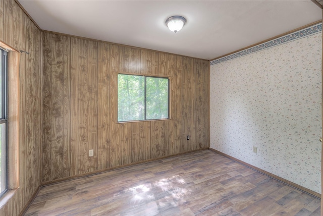 330 Oak Tree Dr, Point Blank, TX 77364 - unfurnished room with wood finished floors, wallpapered walls, and baseboards