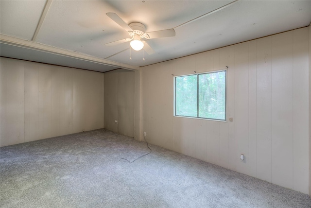 330 Oak Tree Dr, Point Blank, TX 77364 - carpeted empty room with a ceiling fan and wooden walls