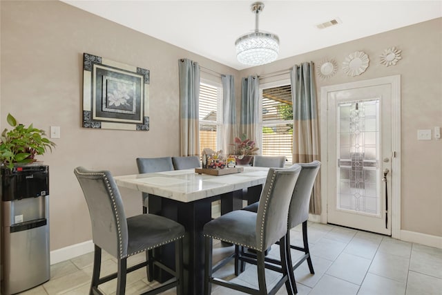 16946 Creek Mountain Dr, Houston, TX 77084 - dining room featuring light tile patterned floors, baseboards, and a chandelier
