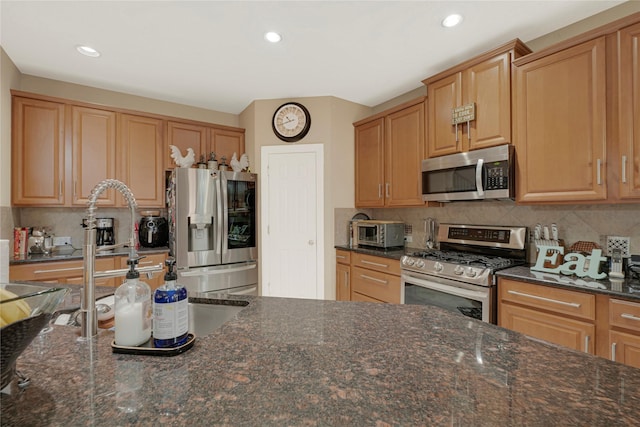 16946 Creek Mountain Dr, Houston, TX 77084 - kitchen with stainless steel appliances, backsplash, dark stone counters, and recessed lighting
