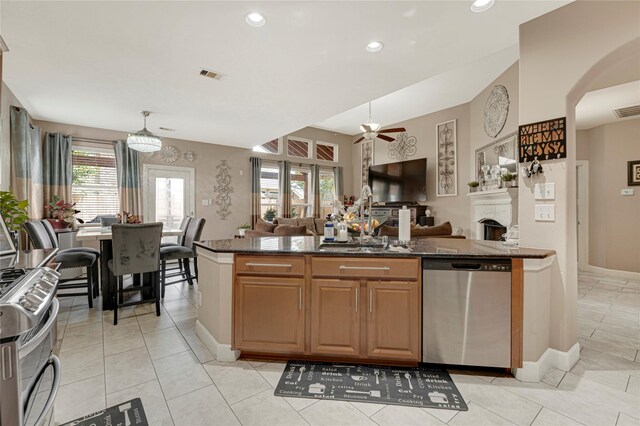 16946 Creek Mountain Dr, Houston, TX 77084 - kitchen with stainless steel appliances, open floor plan, a ceiling fan, a sink, and recessed lighting