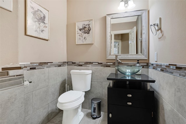 16946 Creek Mountain Dr, Houston, TX 77084 - bathroom with tile walls, toilet, tile patterned flooring, vanity, and wainscoting