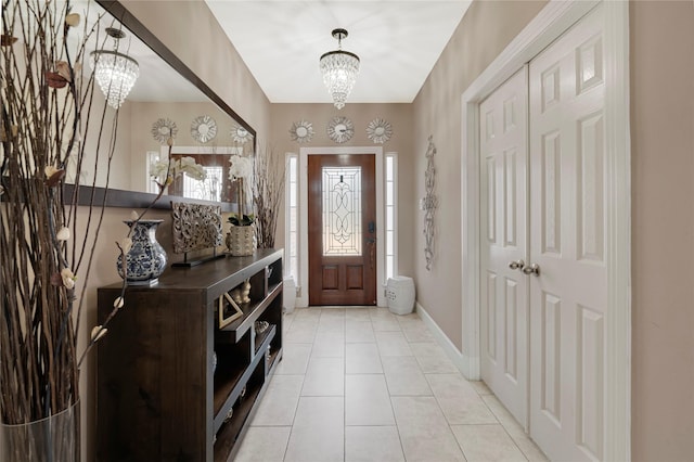 16946 Creek Mountain Dr, Houston, TX 77084 - foyer featuring a chandelier, light tile patterned floors, and baseboards