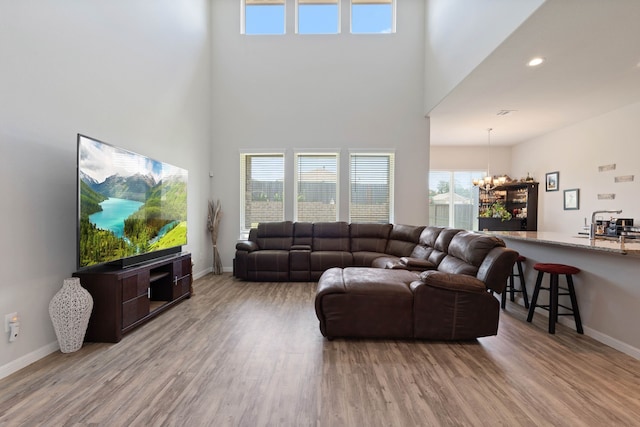 25718 Balsamwood Dr, Tomball, TX 77375 - living area featuring a chandelier, a high ceiling, and wood finished floors
