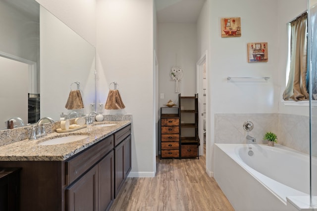25718 Balsamwood Dr, Tomball, TX 77375 - full bathroom featuring double vanity, wood finished floors, and a bath