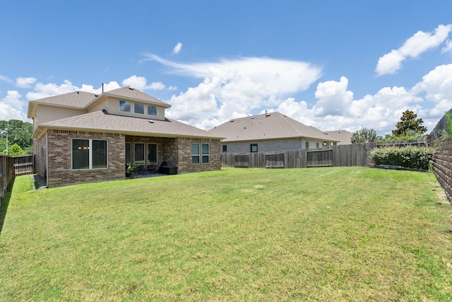 25718 Balsamwood Dr, Tomball, TX 77375 - back of property featuring brick siding, a fenced backyard, and roof with shingles