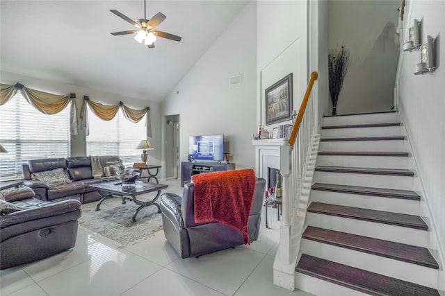 13614 Birch Canyon Ct, Houston, TX 77041 - tiled living area featuring high vaulted ceiling, a ceiling fan, stairs, and a fireplace