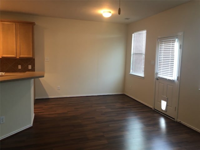2726 Maybrook Hollow Ln, Houston, TX 77047 - unfurnished dining area featuring dark wood-type flooring and baseboards