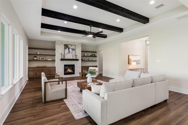 1437 Bluebonnet Ridge Dr, Chappell Hill, TX 77426 - living area with ceiling fan, a fireplace, dark wood-type flooring, beam ceiling, and baseboards