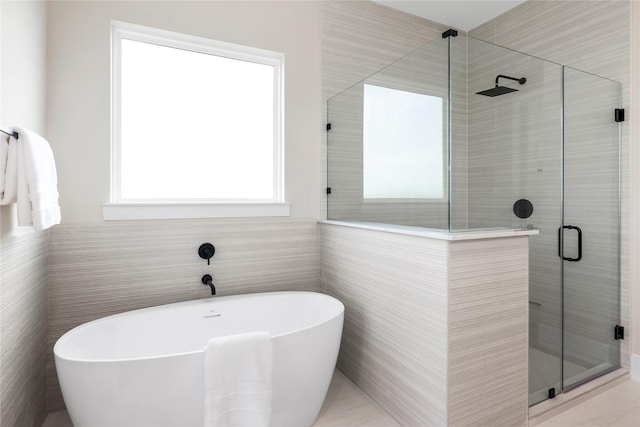1437 Bluebonnet Ridge Dr, Chappell Hill, TX 77426 - full bathroom with a soaking tub, a stall shower, and tile walls