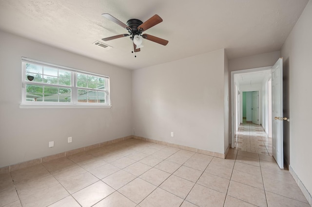 11707 N Nottingham Cir, Houston, TX 77071 - empty room featuring a ceiling fan, attic access, light tile patterned flooring, and baseboards