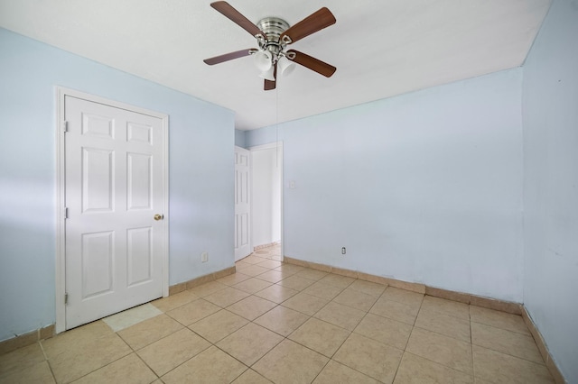 11707 N Nottingham Cir, Houston, TX 77071 - empty room featuring a ceiling fan, baseboards, and light tile patterned floors