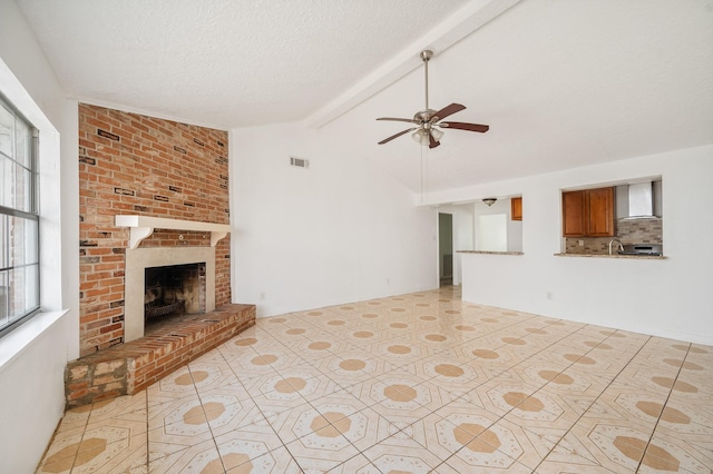 11707 N Nottingham Cir, Houston, TX 77071 - unfurnished living room featuring ceiling fan, a fireplace, a textured ceiling, and a sink