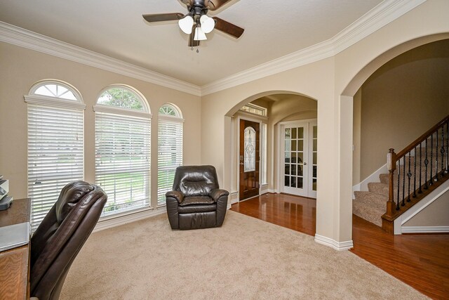 20803 Twisted Leaf Dr, Cypress, TX 77433 - carpeted home office featuring arched walkways, ornamental molding, ceiling fan, wood finished floors, and french doors