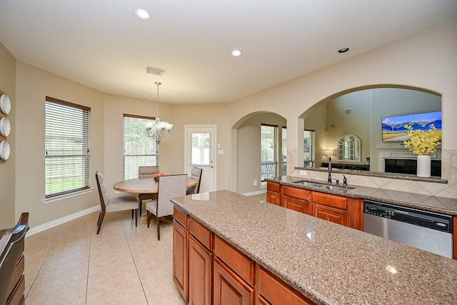 20803 Twisted Leaf Dr, Cypress, TX 77433 - kitchen with stainless steel dishwasher, brown cabinets, pendant lighting, a chandelier, and healthy amount of natural light