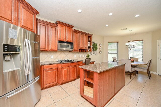 20803 Twisted Leaf Dr, Cypress, TX 77433 - kitchen with appliances with stainless steel finishes, open shelves, tasteful backsplash, stone counters, and a chandelier