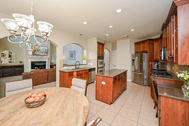 20803 Twisted Leaf Dr, Cypress, TX 77433 - kitchen with stainless steel appliances, light tile patterned flooring, a chandelier, a center island, and recessed lighting