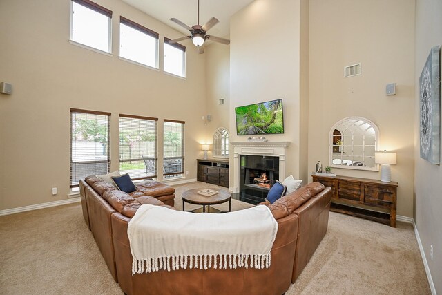 20803 Twisted Leaf Dr, Cypress, TX 77433 - living area featuring a towering ceiling, a ceiling fan, a tile fireplace, and carpet flooring